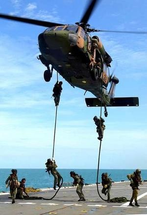 Australian SAS troopers conducting a fast rope exercise from a B