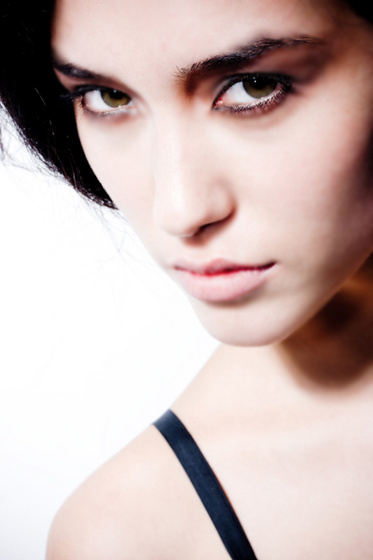 girl with green eye and black hair and black paint